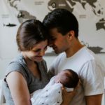 Young family - mother holding baby with father